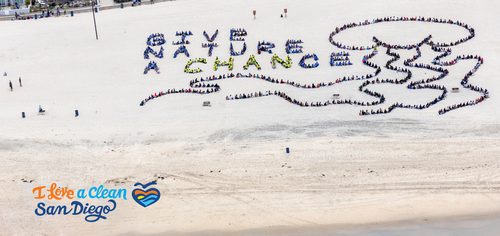 People who participated in the beach cleanup lined up to form the words GIVE NATURE A CHANCE
