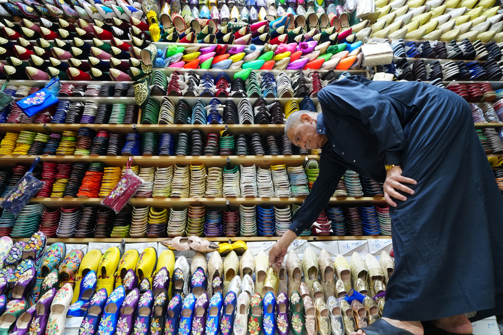Sample image of an old man and his stall selling colourful Moroccan slippers Creative Look: Vivid