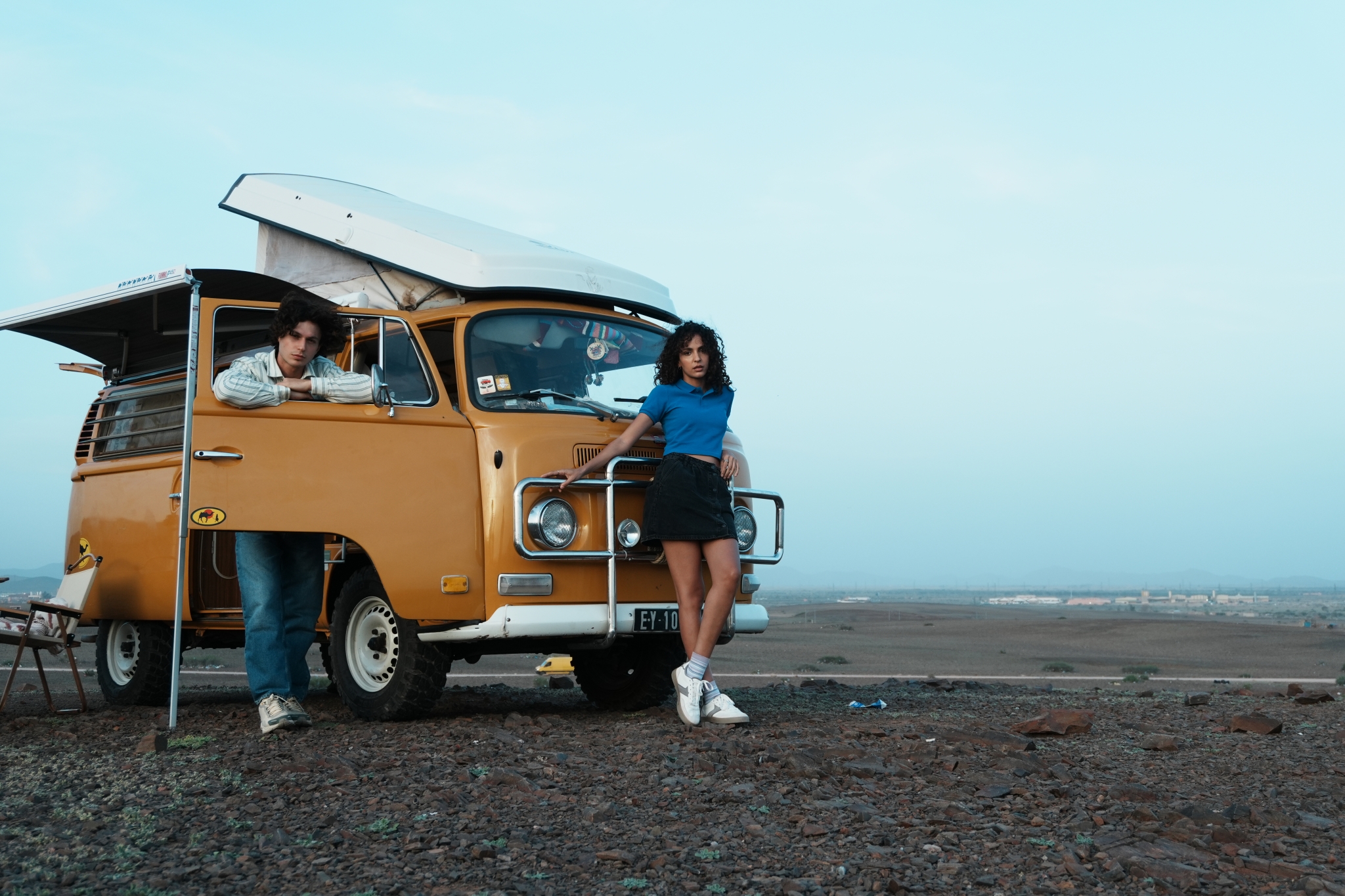 Sample image of a man and a woman leaning against the yellow van Creative Look: Film