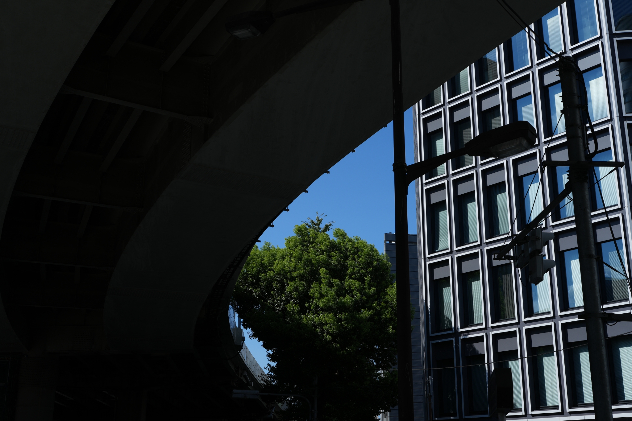 An image with a strong contrast between the underpass and the buildings Click to open modal