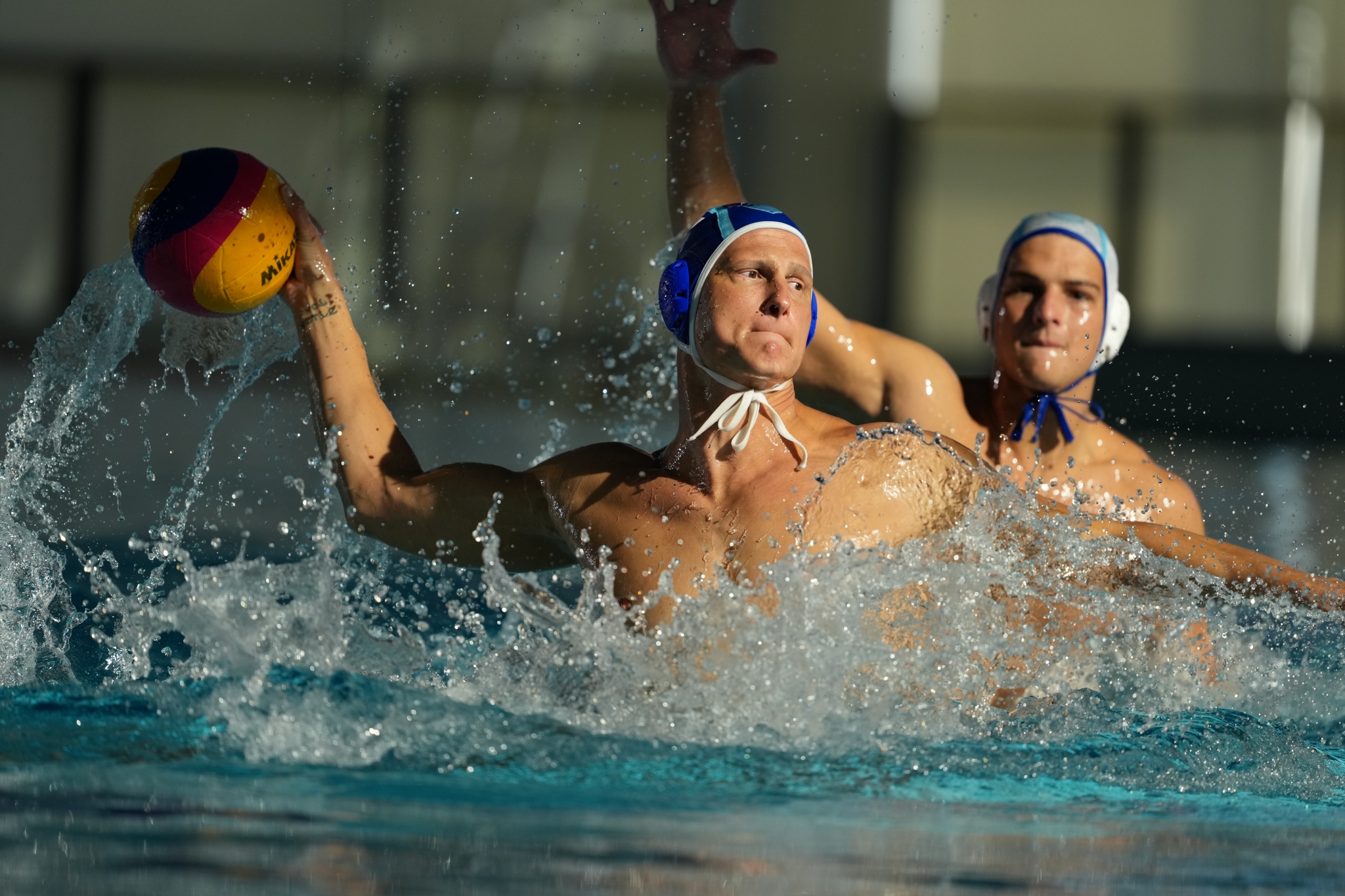 Example image showing a man about to shoot the ball in a water polo game Click to open modal