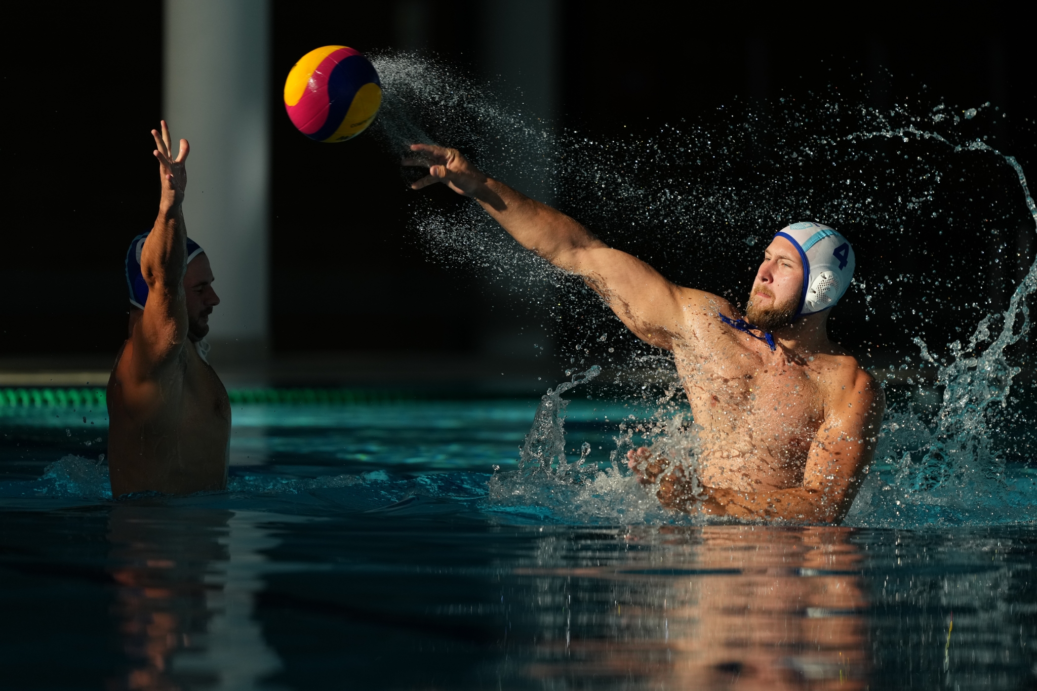 Example image showing a man shooting the ball in a water polo game Click to open modal