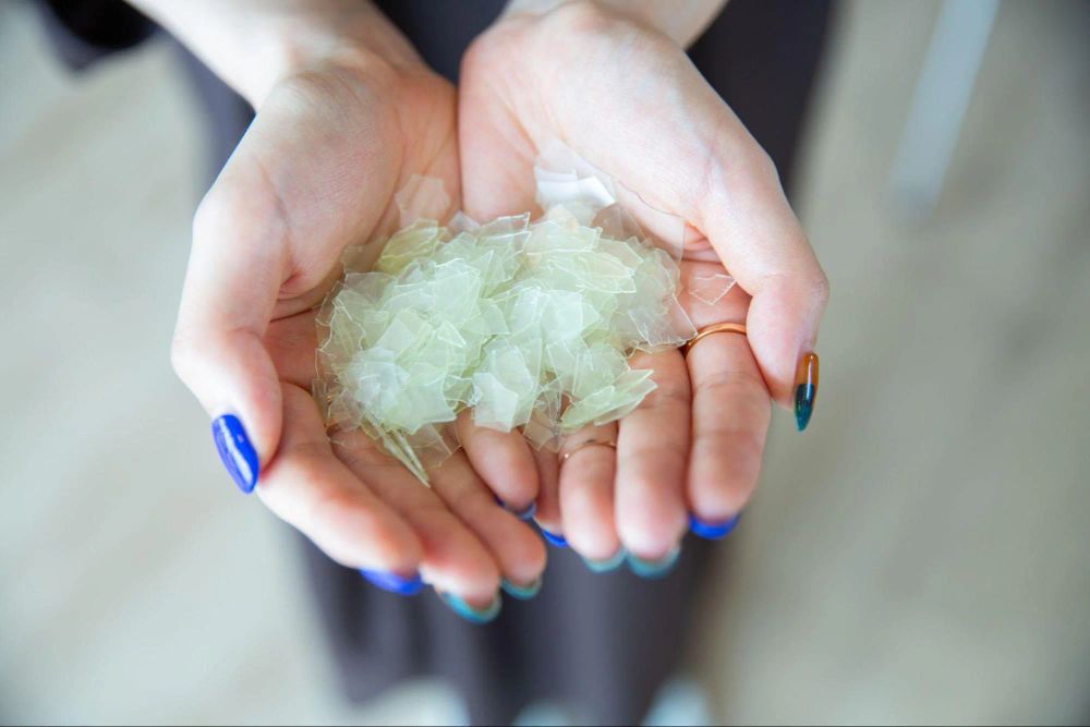 Photo of samples of recycled raw material on Mariko's hands